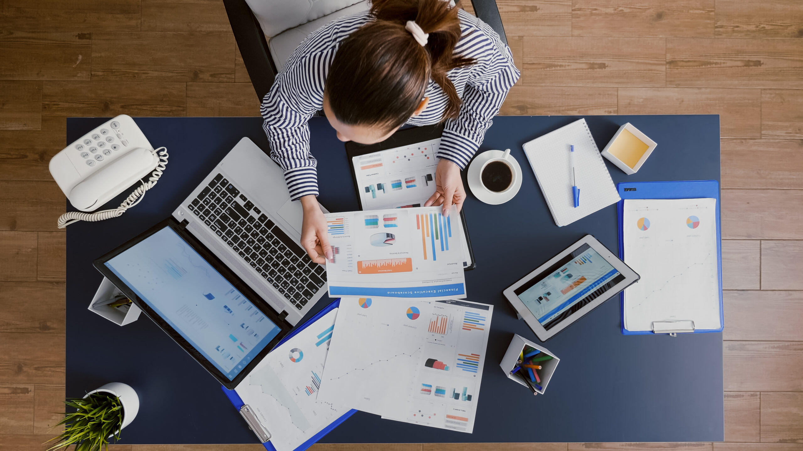 top-view-of-businesswoman-sitting-at-desk-table-checking-financial-accounting-documents.jpg